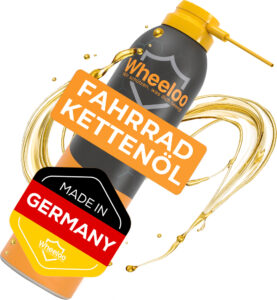 Schwarze und orange Sprühflasche mit Fahrradkettenöl und "Made in Germany"-Aufschrift.